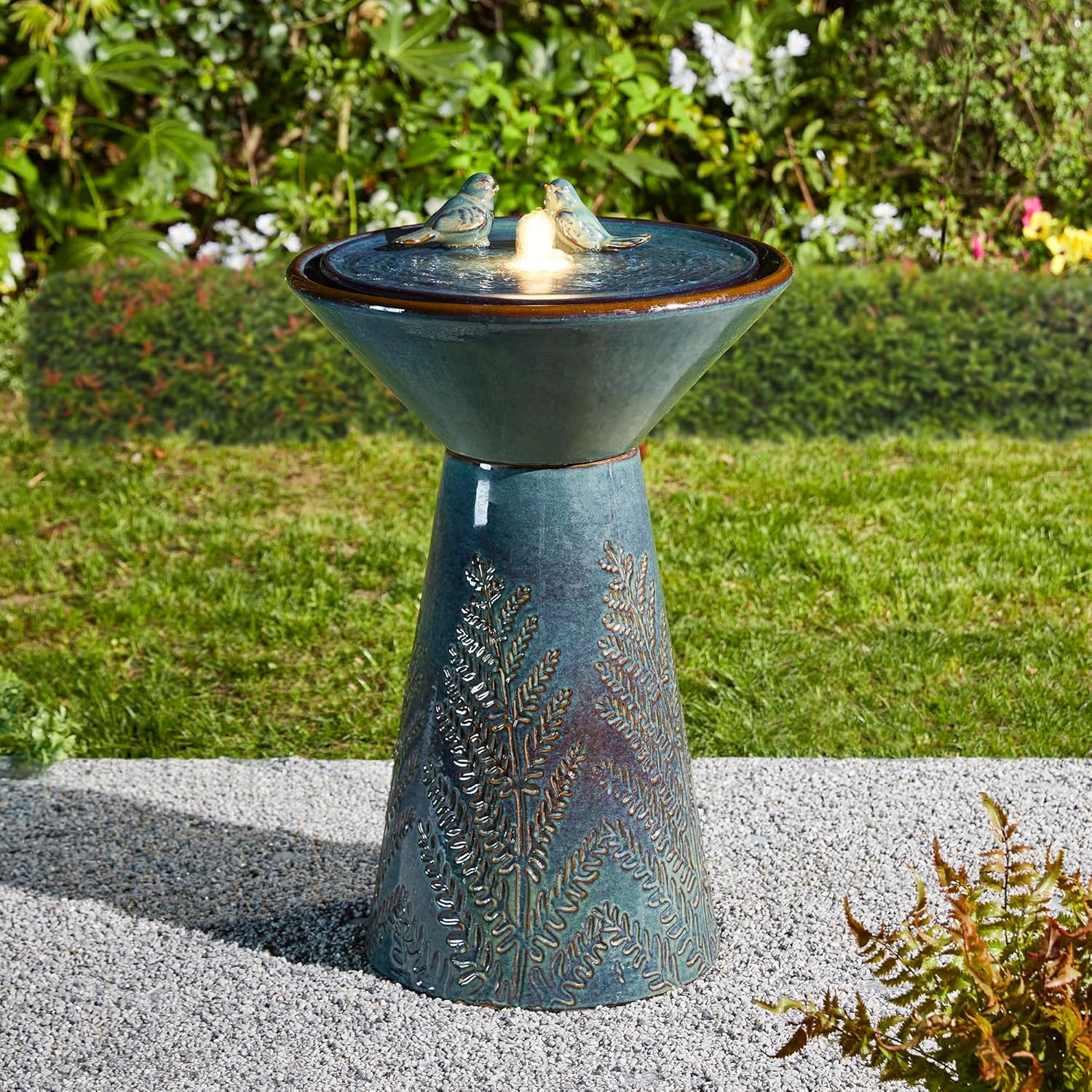 Image of the fully assembled Glitzhome Ceramic Garden Water Fountain in a garden setting.