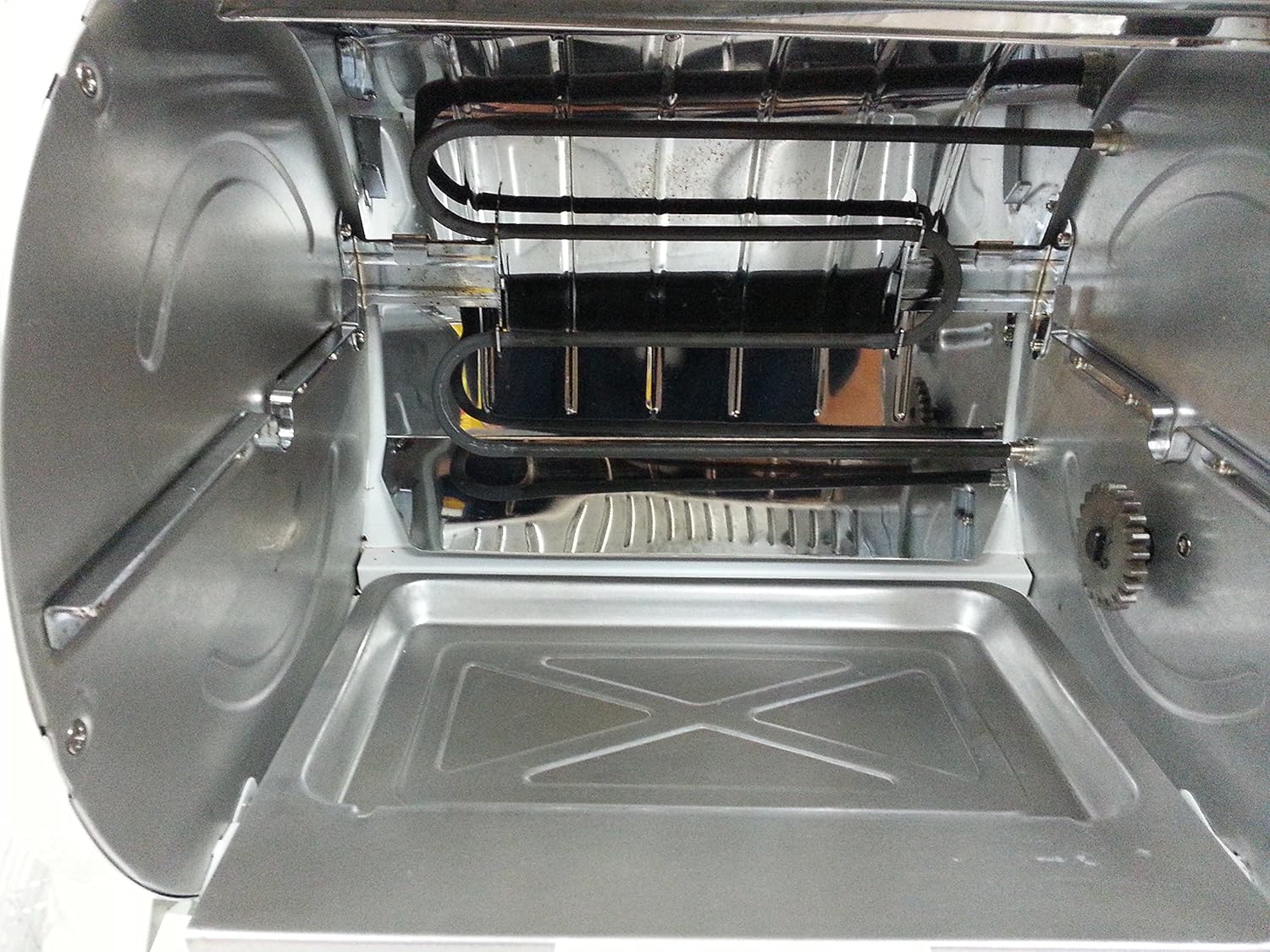 Interior view of the George Foreman GR82B Rotisserie showing the heating elements and the removable drip tray at the bottom.