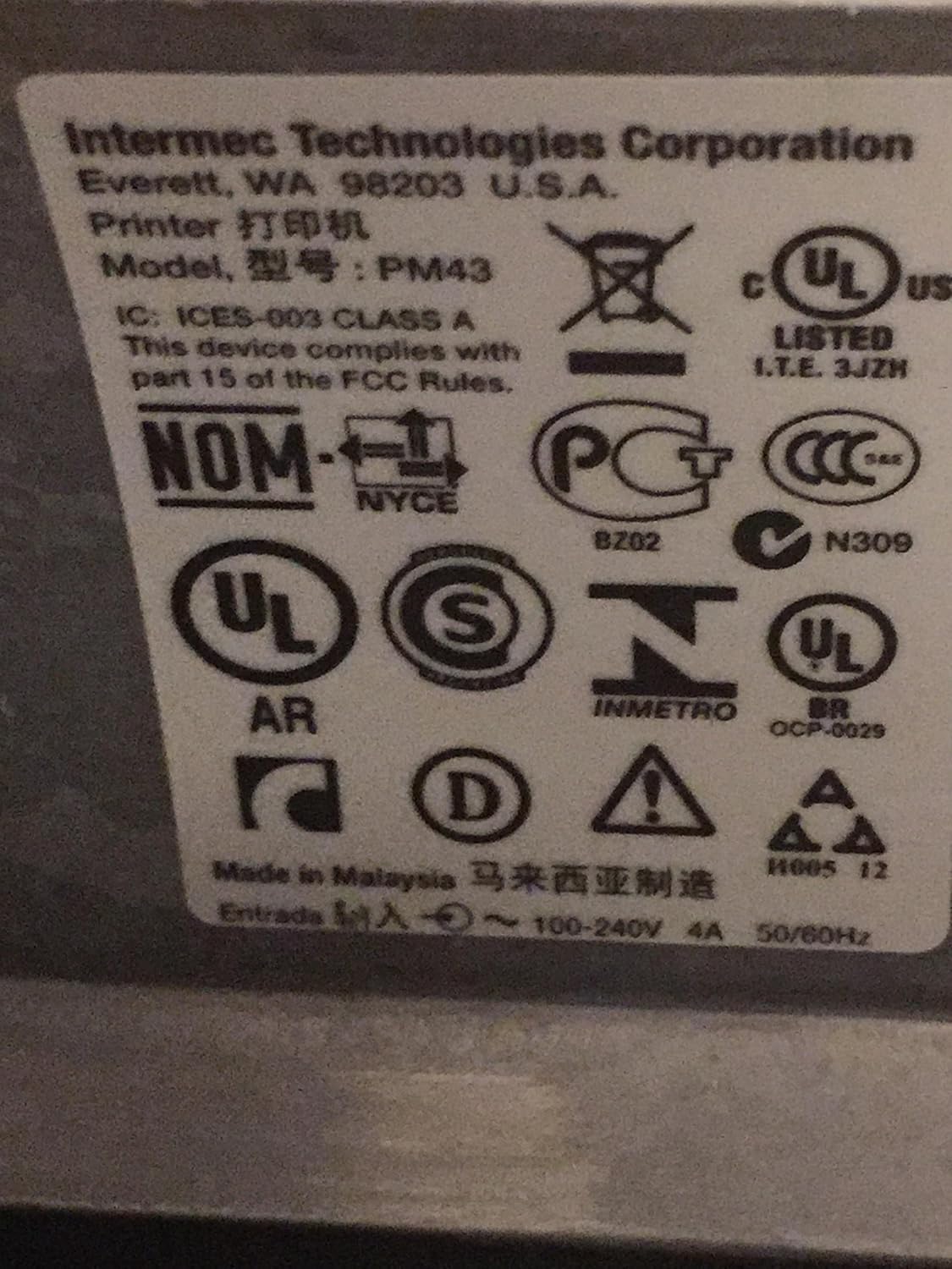 Close-up of regulatory labels on Intermec PM43 printer