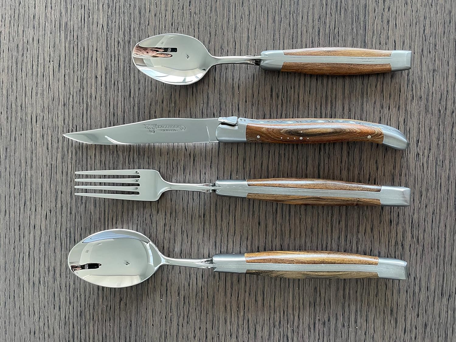 Laguiole en Aubrac Luxury 28-Piece Flatware Set With 6 Fully Forged Steak Knives, 6 Forks, Carving Set, Cheese Set, 6 Soup Spoons & 6 Tea Spoons, Pistachio Wood Handles, Stainless Steel Matte Bolsters