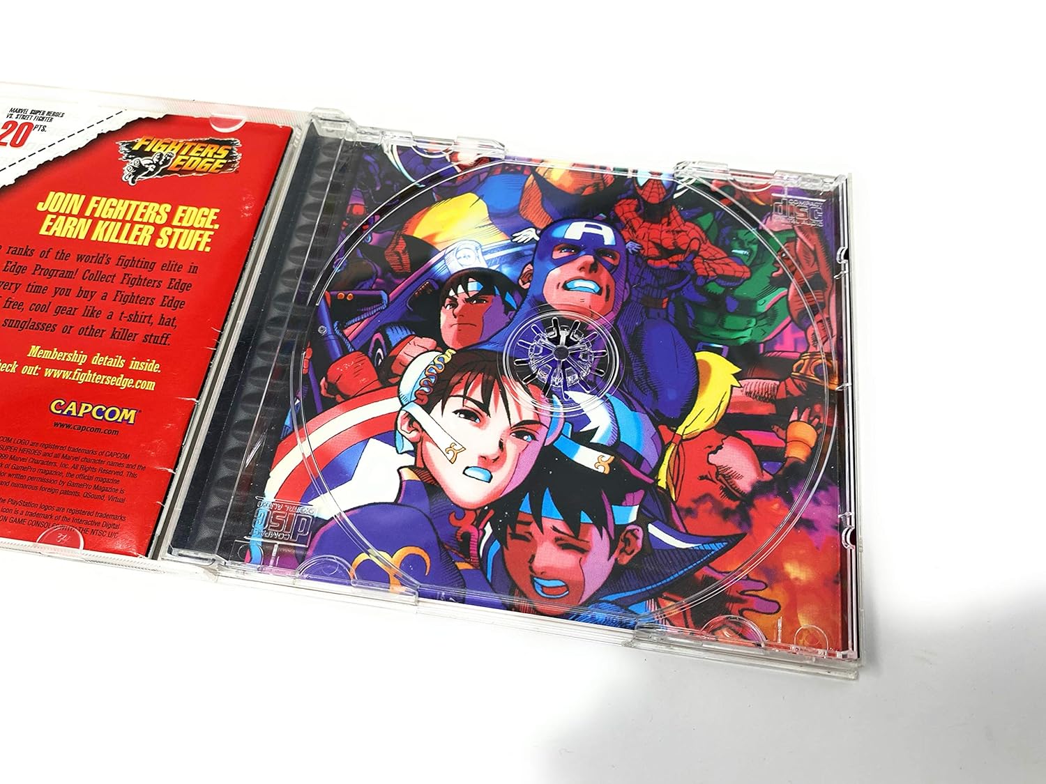 The Marvel Super Heroes Vs. Street Fighter game disc with character artwork, including Ryu, Captain America, and Spider-Man.