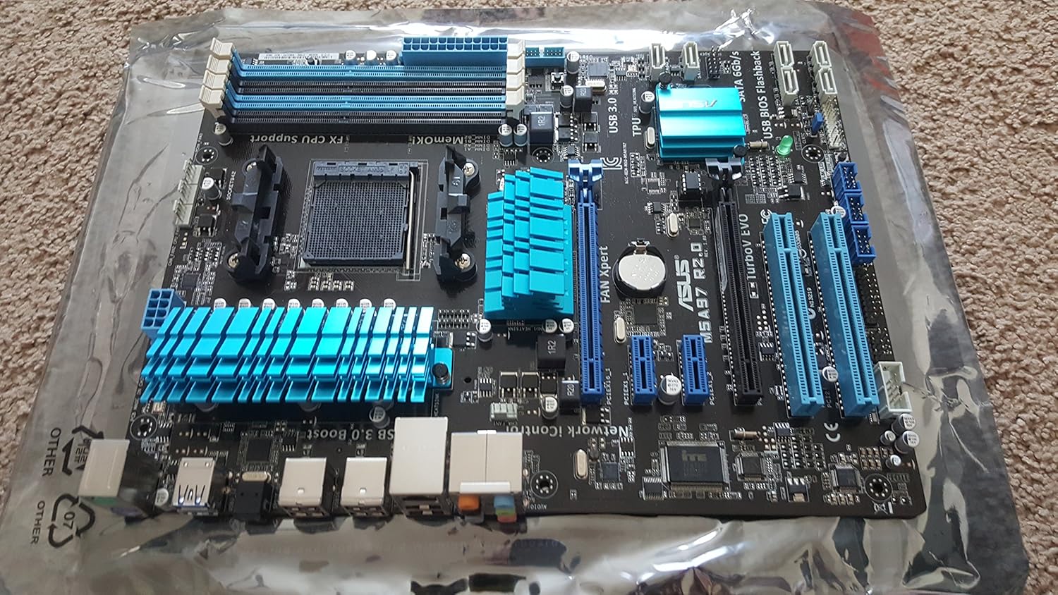 Top-down view of the ASUS M5A97 R2.0 motherboard, highlighting various components and slots.