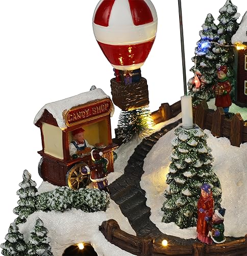 Miniatura 3 de Alpine Corporation Decoración de mesa animada de pueblo navideño de 11 pulgadas de alto con tren móvil, globo de aire caliente y luces LED