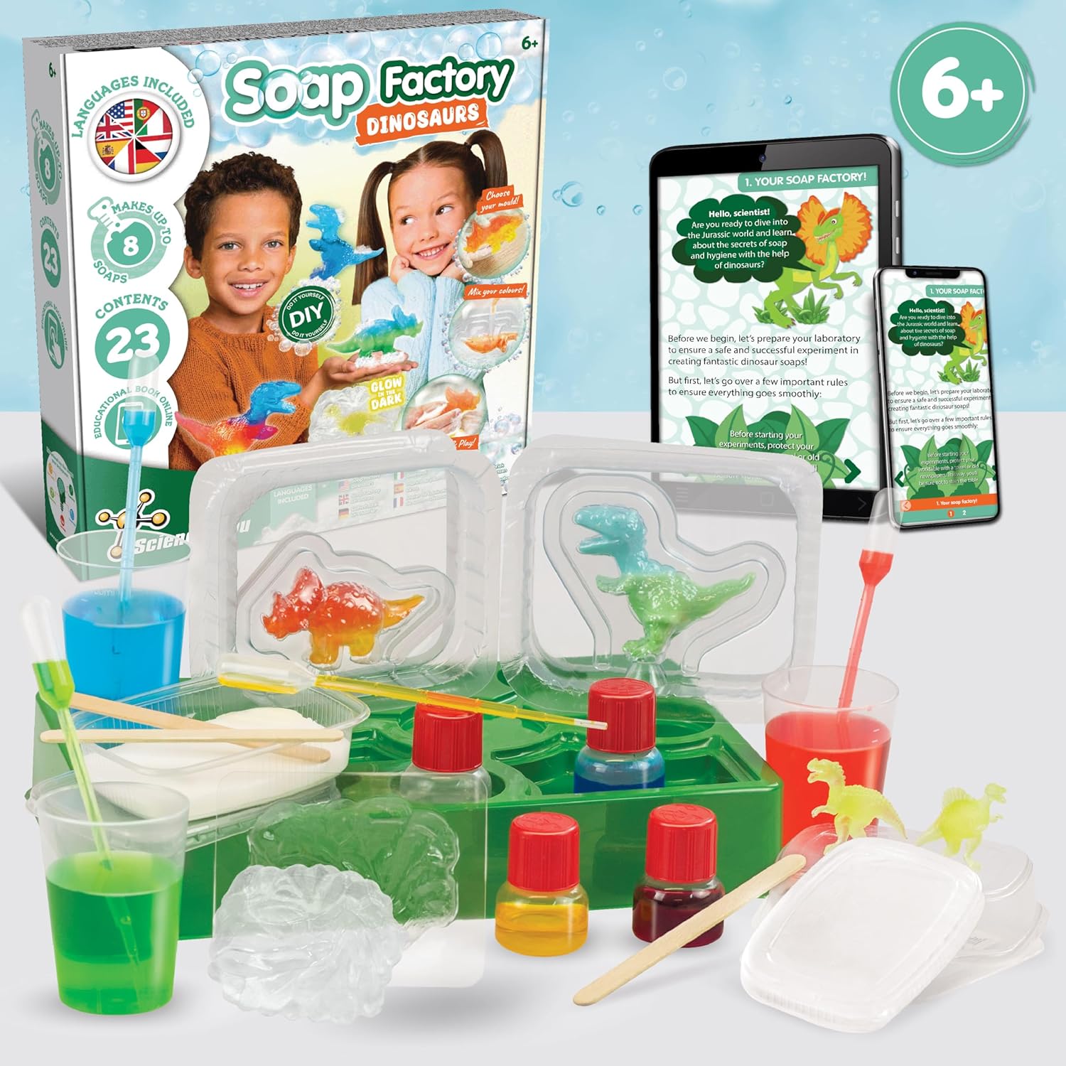 Contents of Science4you Dinosaur Lab Soap Making Kit laid out with a tablet showing the online educational book