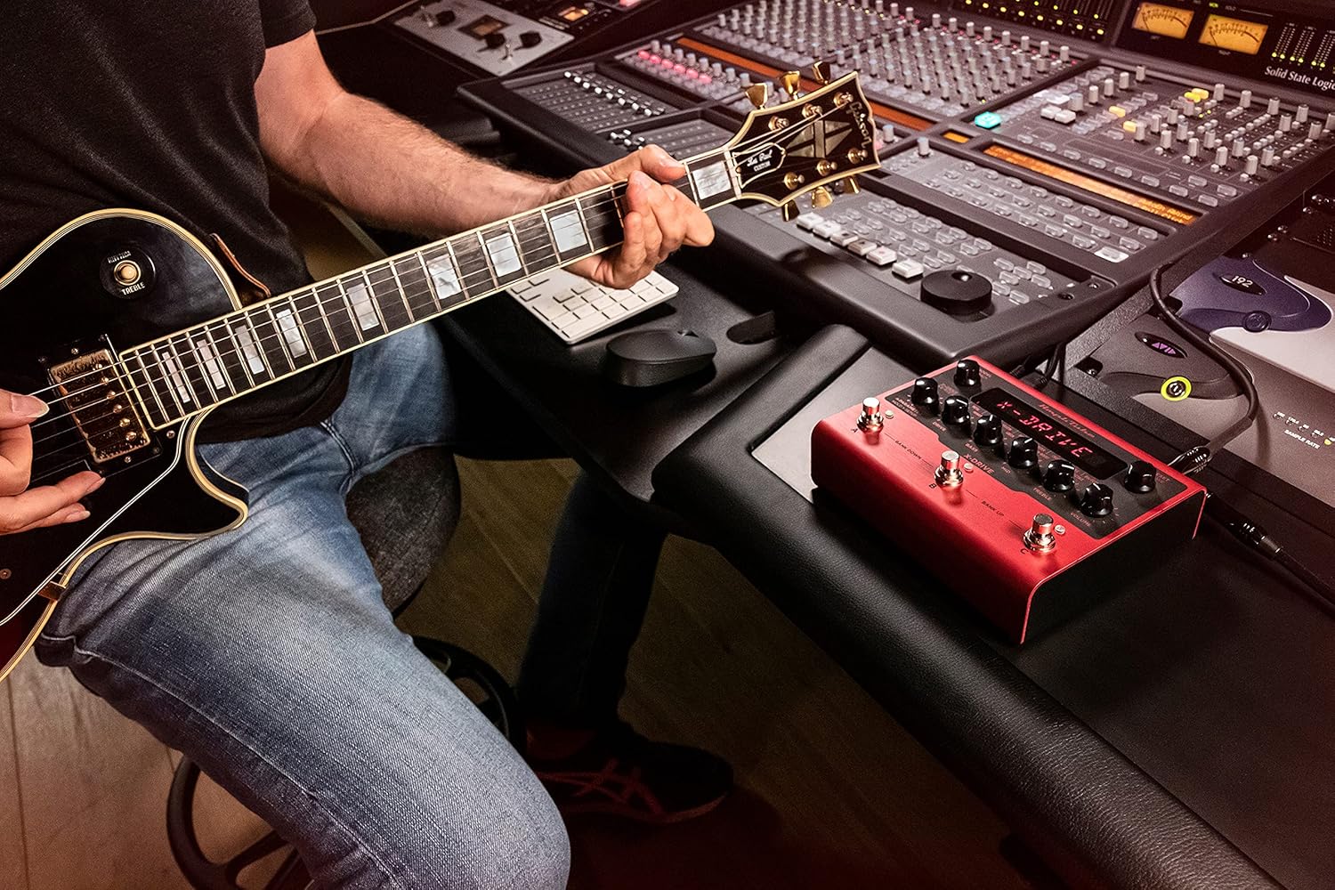 IK ملٽي ميڊيا AmpliTube X-DRIVE pedal integrated into a studio environment with a guitar