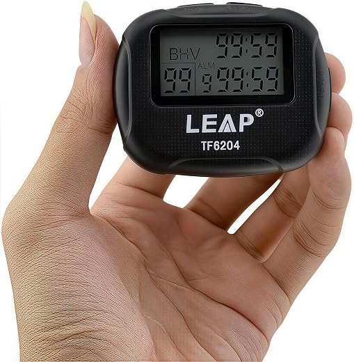 Hand holding a black digital interval timer with a dual time display