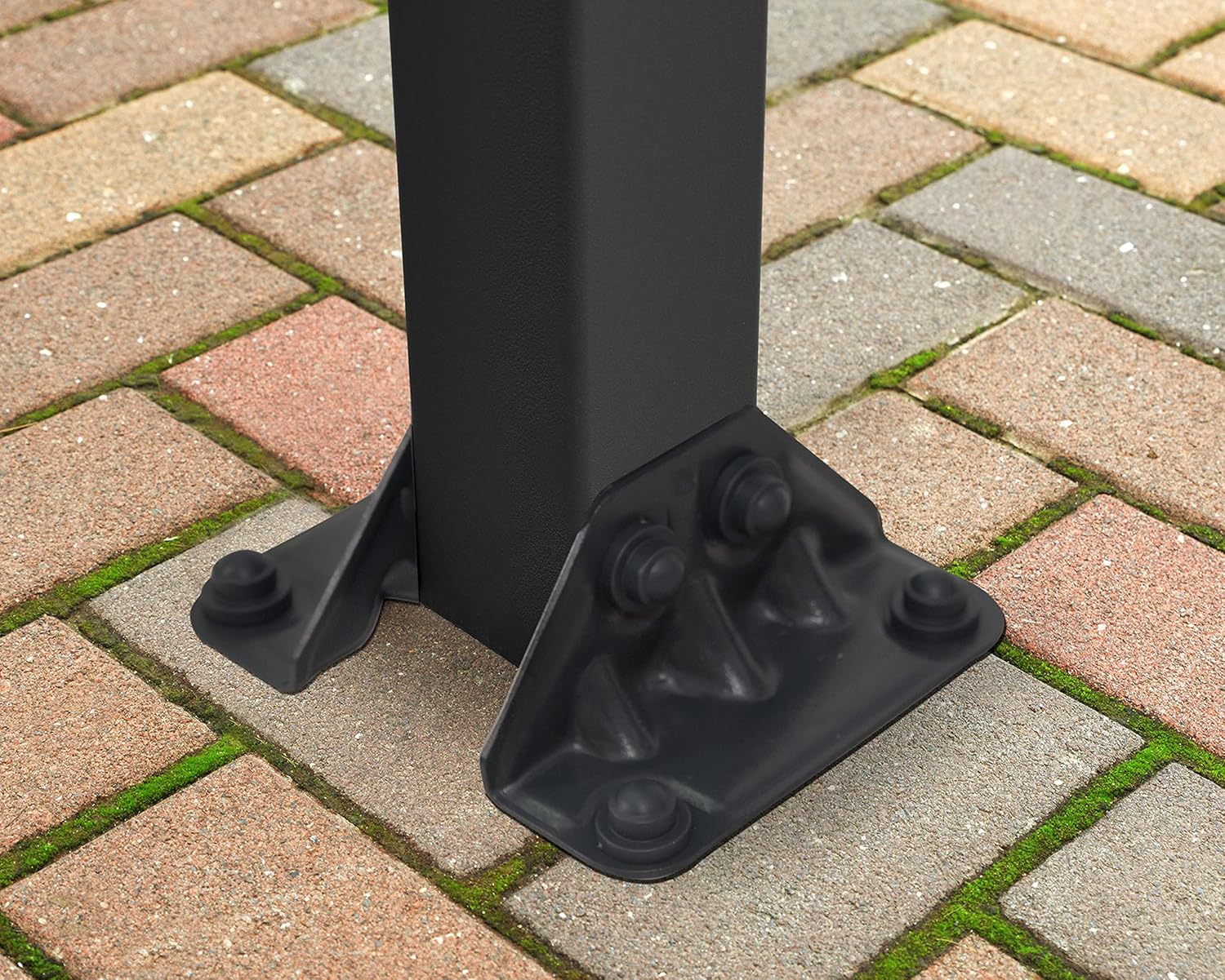 Close-up of the patio cover's post base securely bolted to the ground