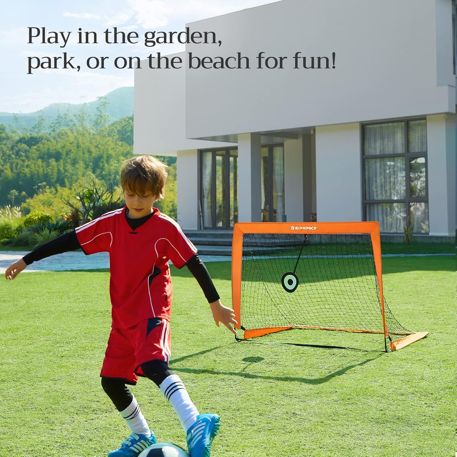 Close-up view of a soccer ball in the net, and a J-shaped stake securing the goal frame to the grass.