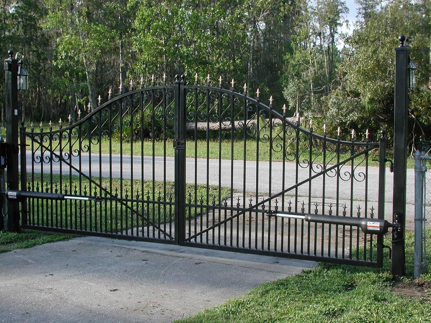 Installed Mighty Mule FM502 gate opener on a closed dual swing gate