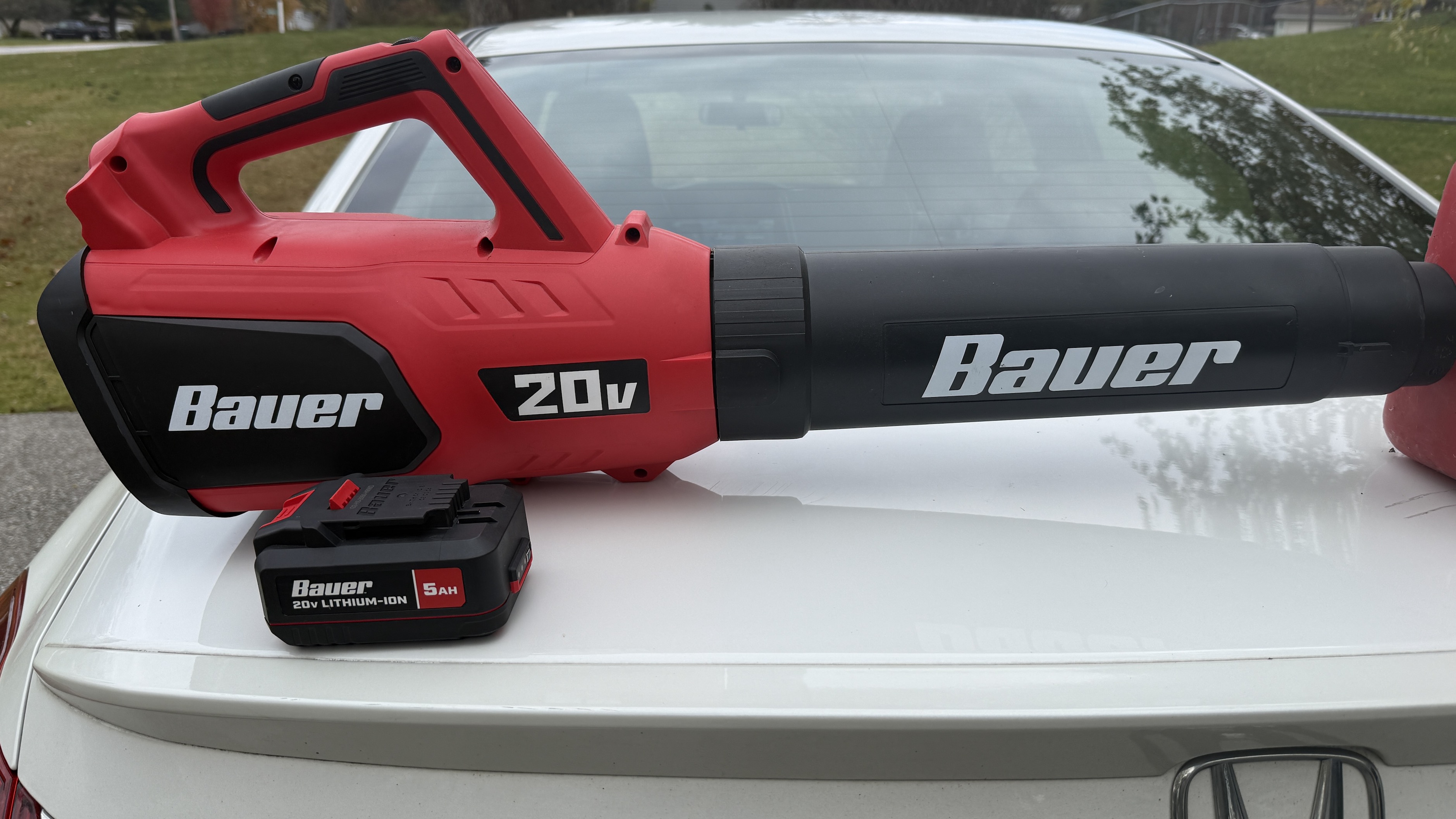 Bauer 20V Lithium-Ion battery being inserted into the Rapid Charging Battery Charger