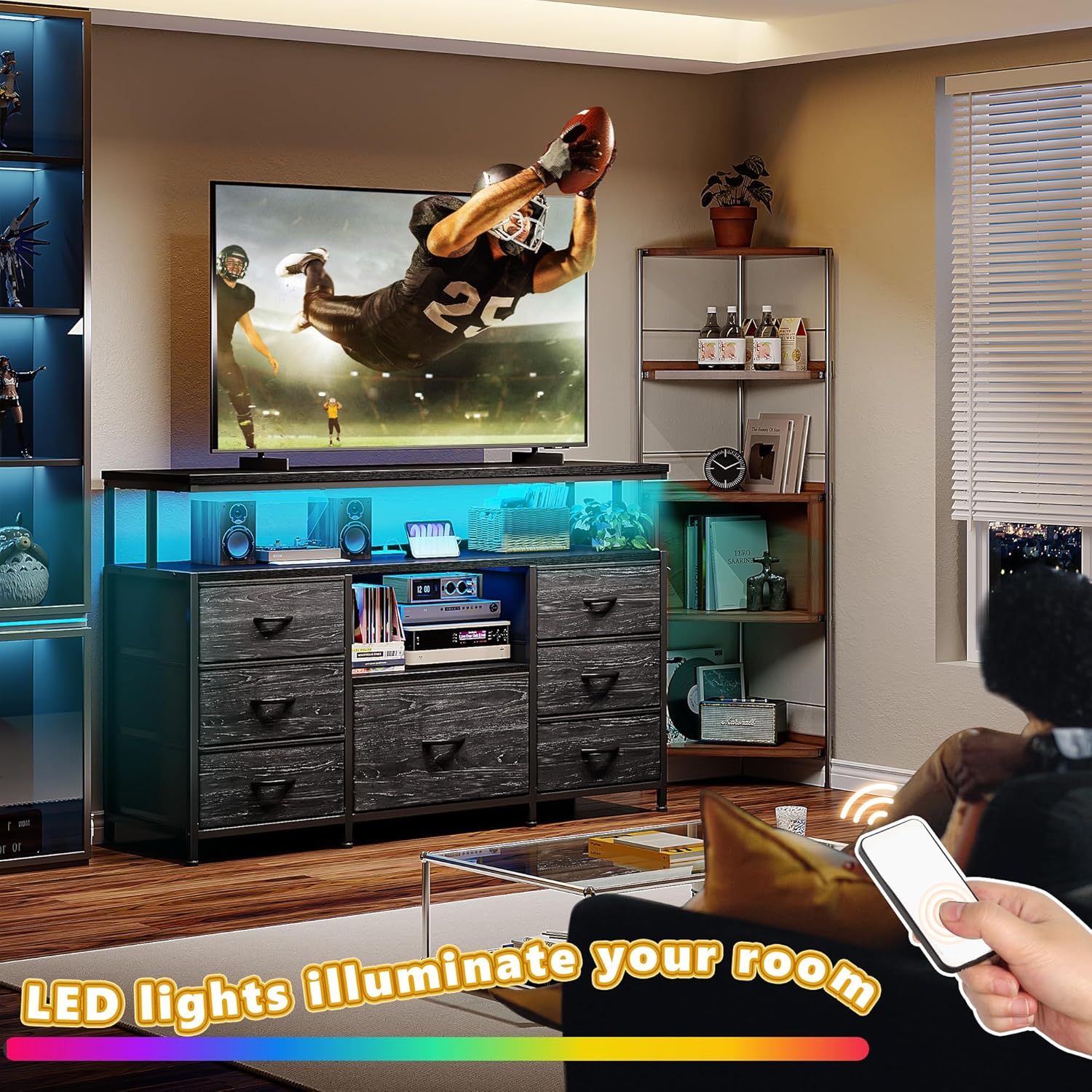 Person using a remote control to change LED lights on the TV stand dresser