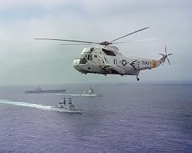 A Helicopter Anti-submarine Squadron 8 (HS-8) SH-3H Sea King helicopter hovers near the Aircraft Carrier USS CONSTELLATION (CV 64) - 20 Inch by 30 Inch Laminated Poster - Bright Colors And Vivid Imagery