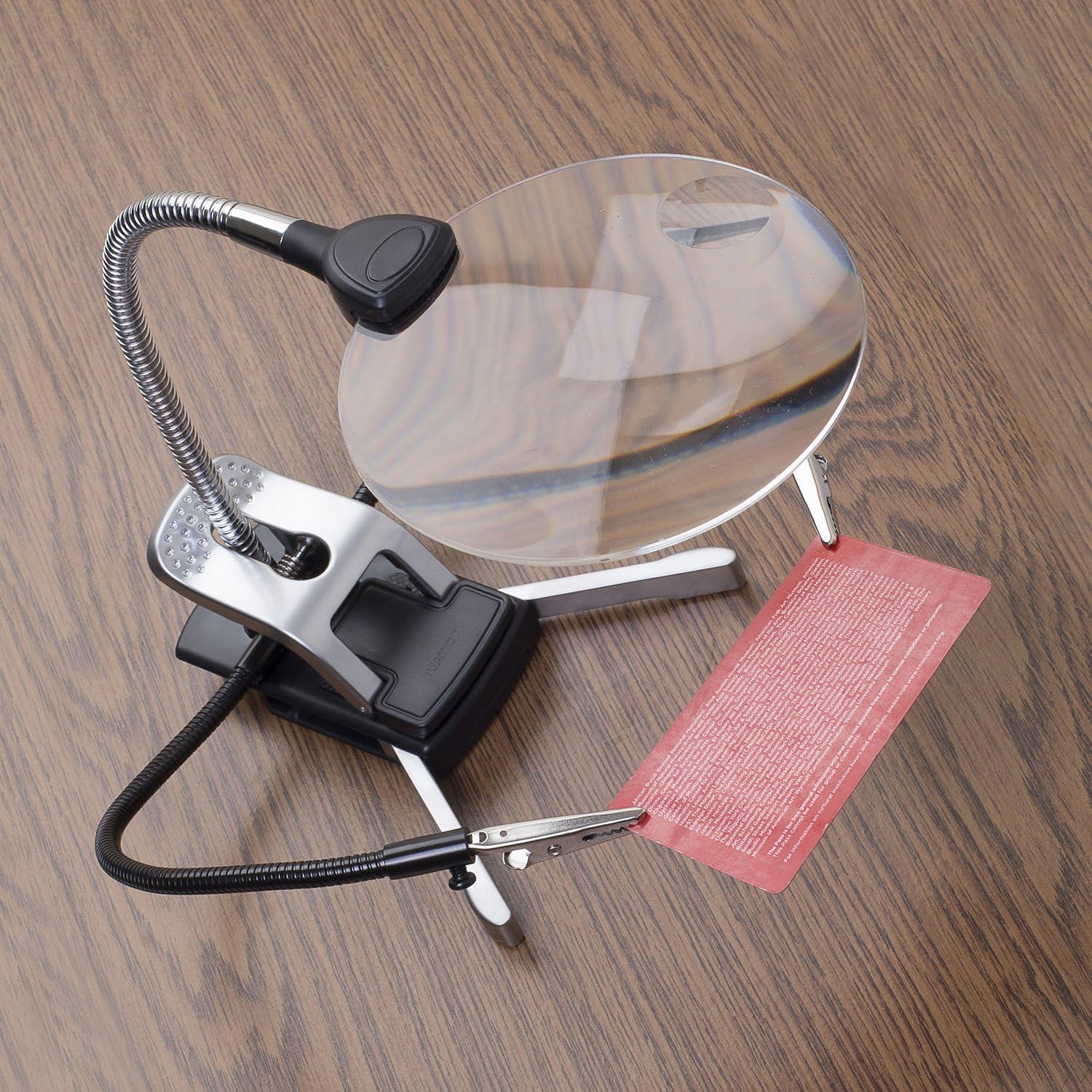 Ivation LED Magnifier clipped to a desk, illuminating a keyboard