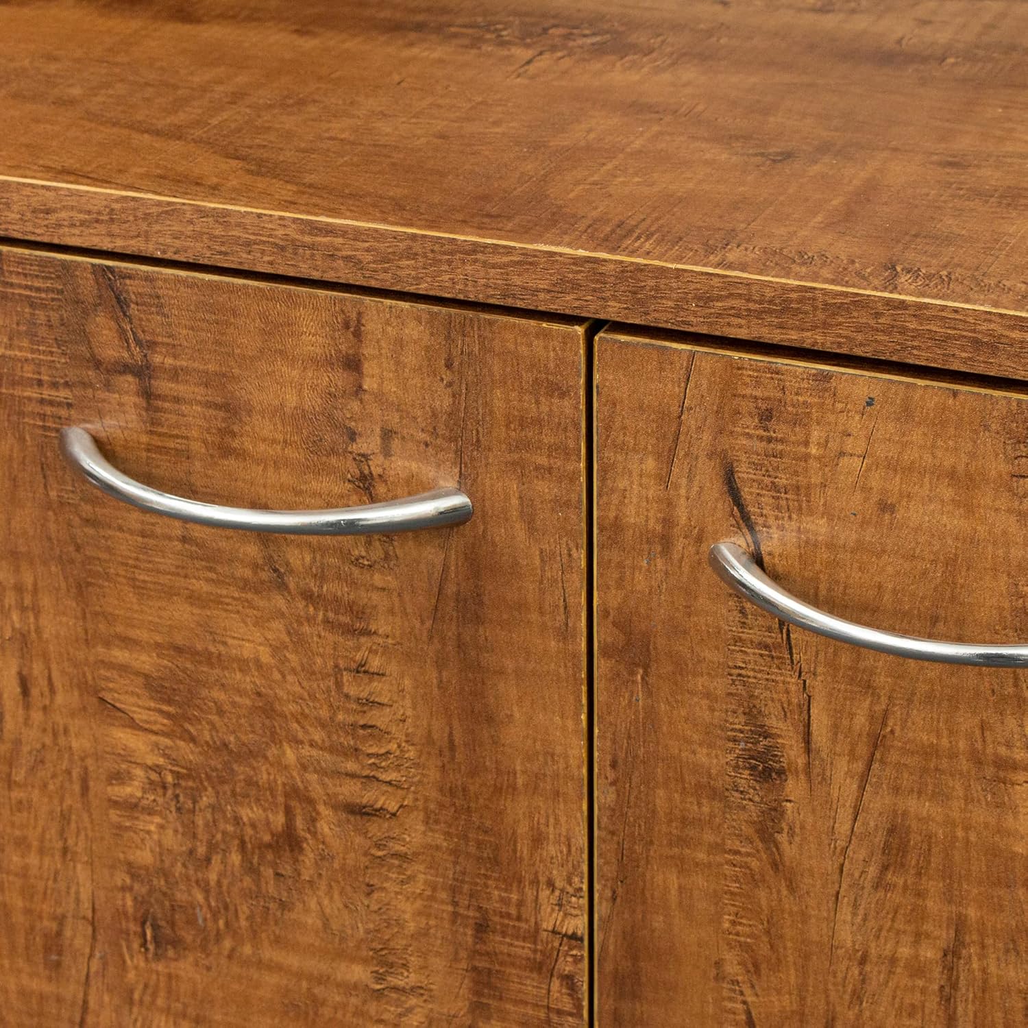 Close-up of two cabinet doors with their metal handles, showing the walnut finish texture.