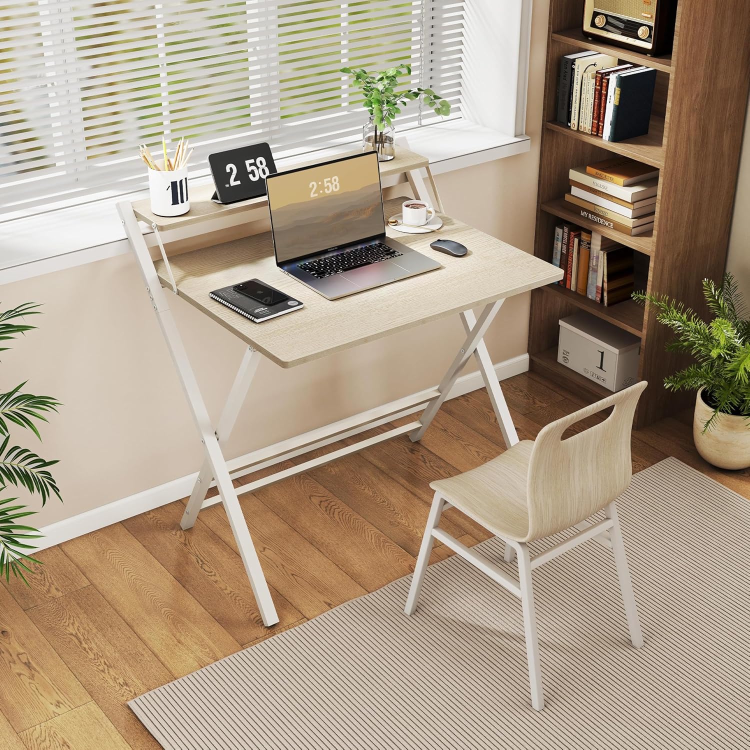 Yaheetech folding computer desk in a home office setting with a laptop and monitor stand