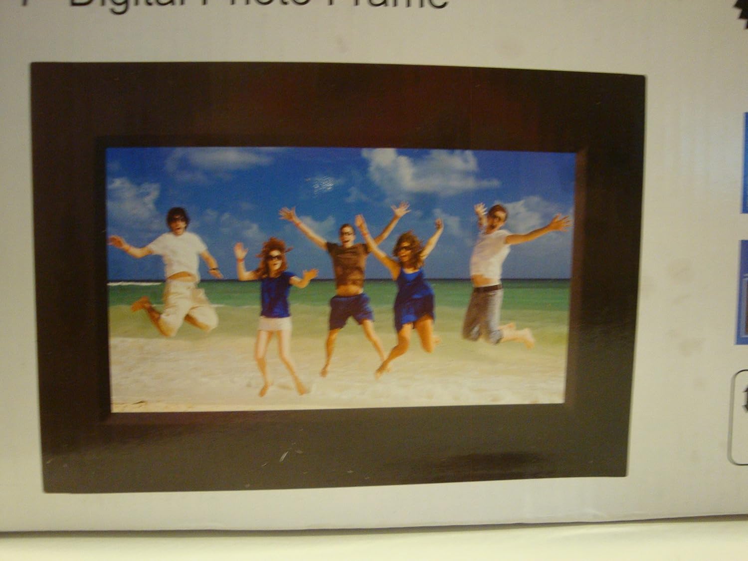 Sylvania SDPF757 7-inch Digital Photo Frame displaying a vibrant image of five people jumping on a beach.
