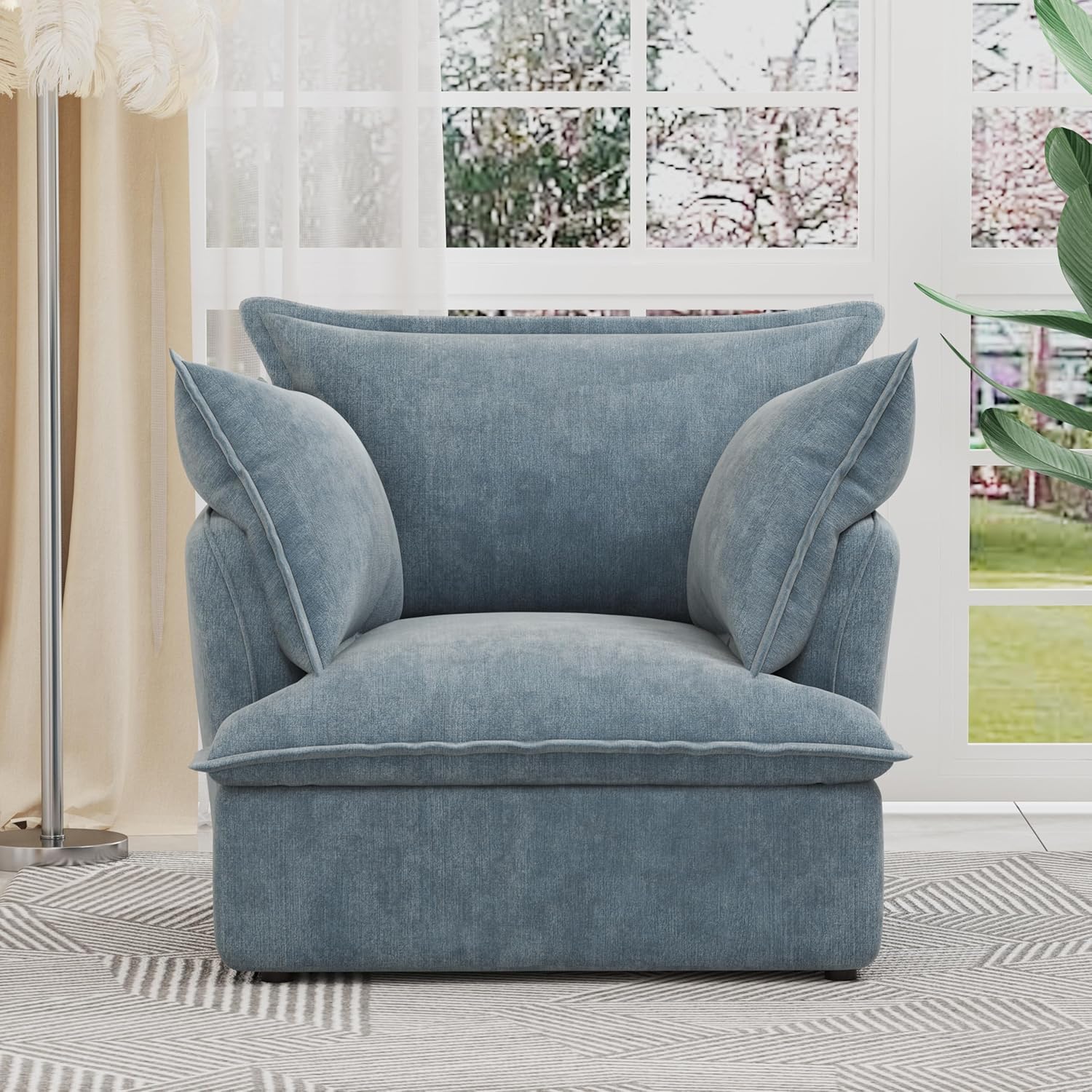 Урд view of the blue chenille armchair in a room setting.