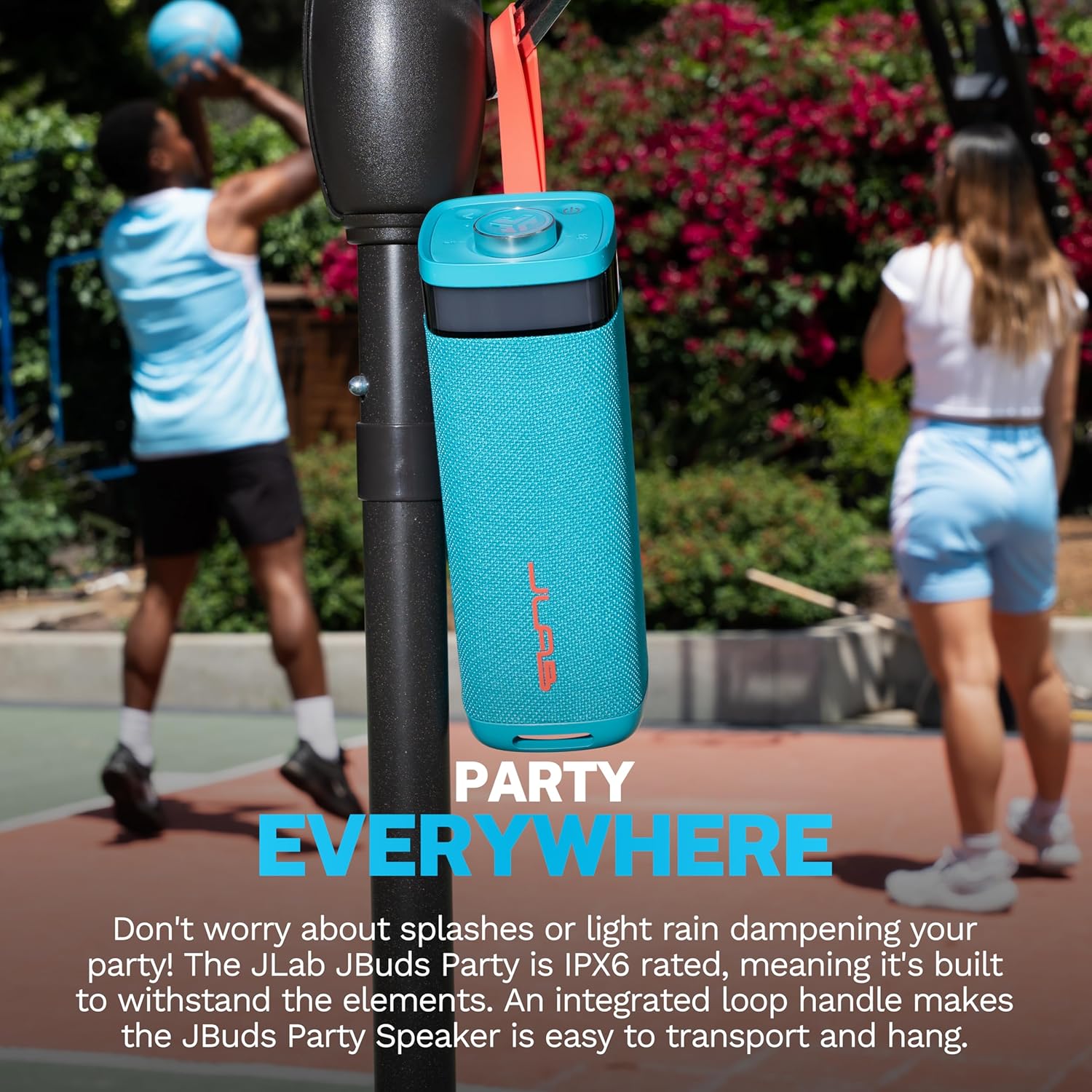 JLab JBuds Party speaker hanging outdoors on a basketball hoop