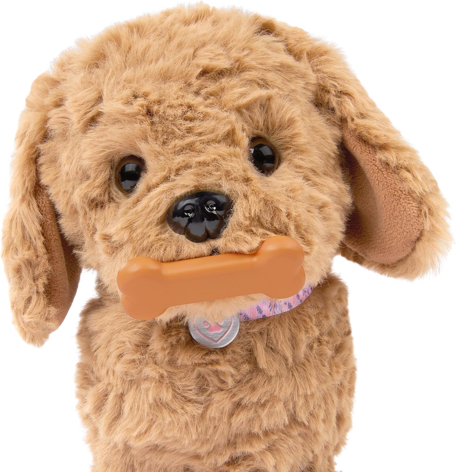 A child feeding the Our Generation Goldendoodle Pup a magnetic bone, activating eating sounds.