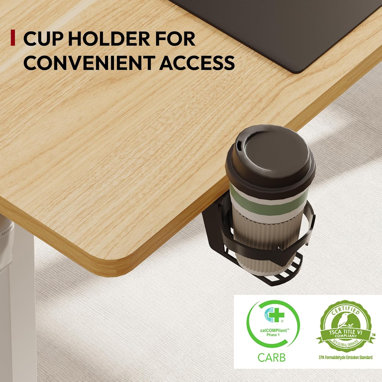 Close-up of the integrated cup holder on the SANODESK desk, holding a coffee cup, with CARB and TSCA Title VI compliant certifications visible.