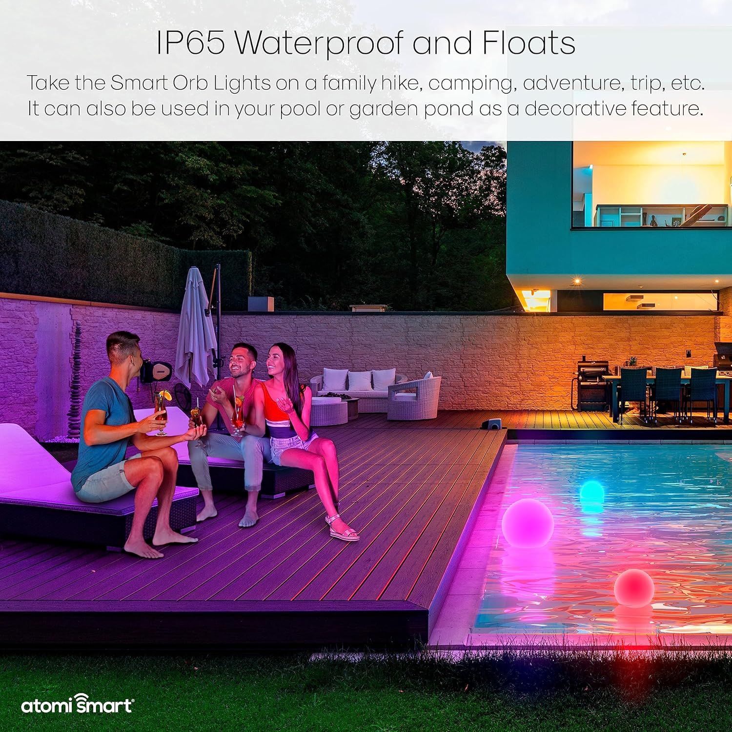Atomi Smart Orb Lights floating in a swimming pool at night, providing decorative lighting.