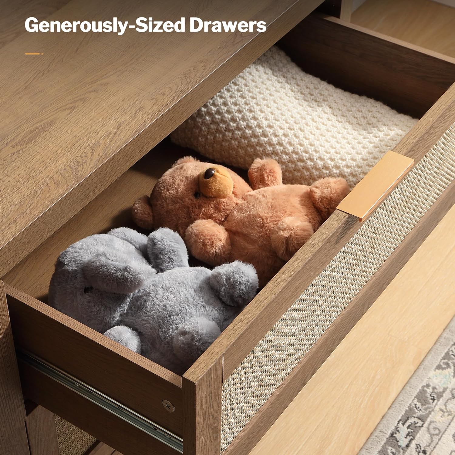 Open dresser drawer filled with folded clothes and stuffed animals