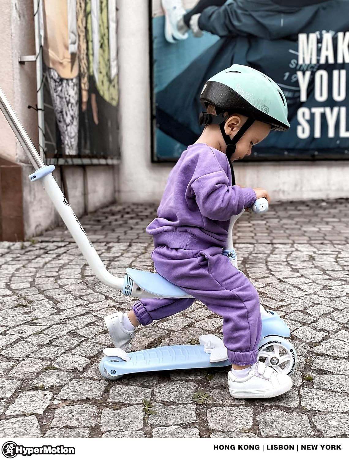 Child riding HyperMotion scooter with seat, side view