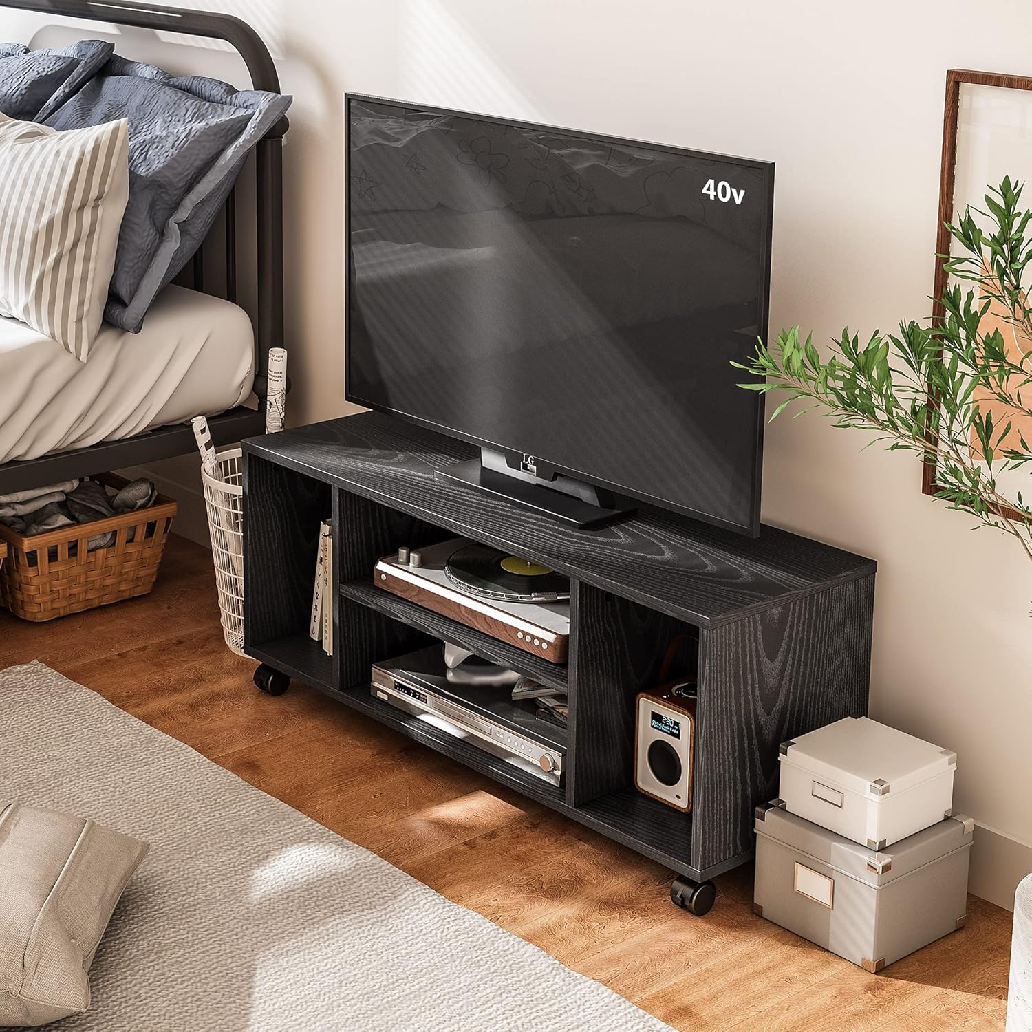 A black TV stand with a television on top, positioned in a living space.