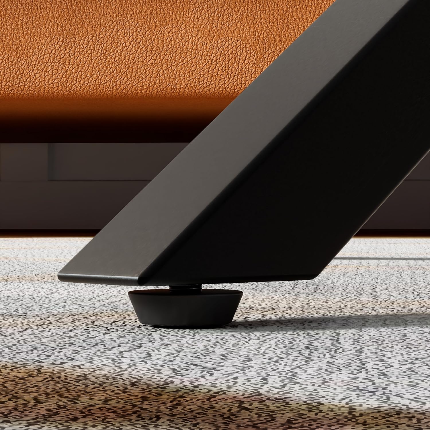 Close-up of an adjustable foot pad on a table leg