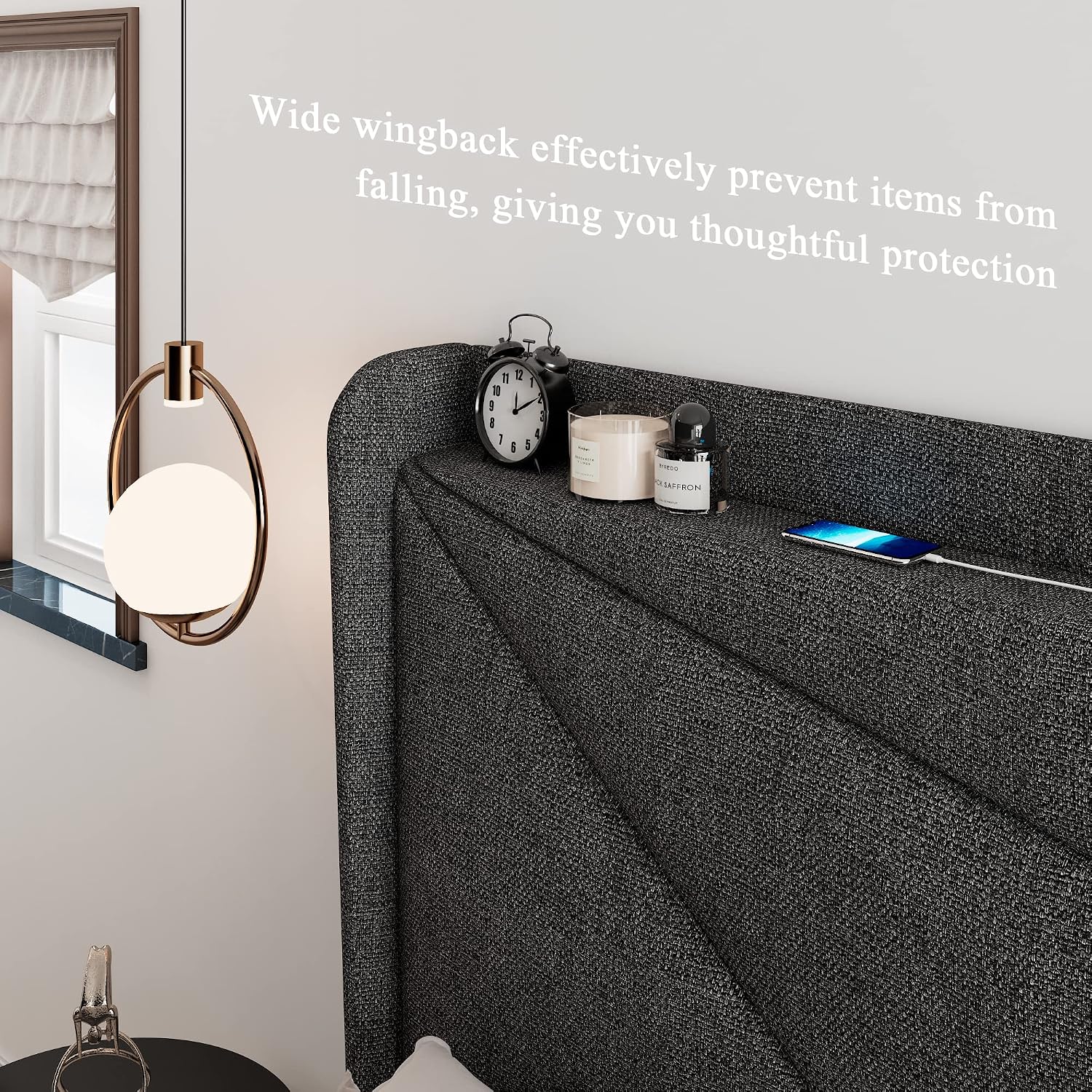 Side view of the headboard's wingback shelf with an alarm clock, candle, and phone on it.