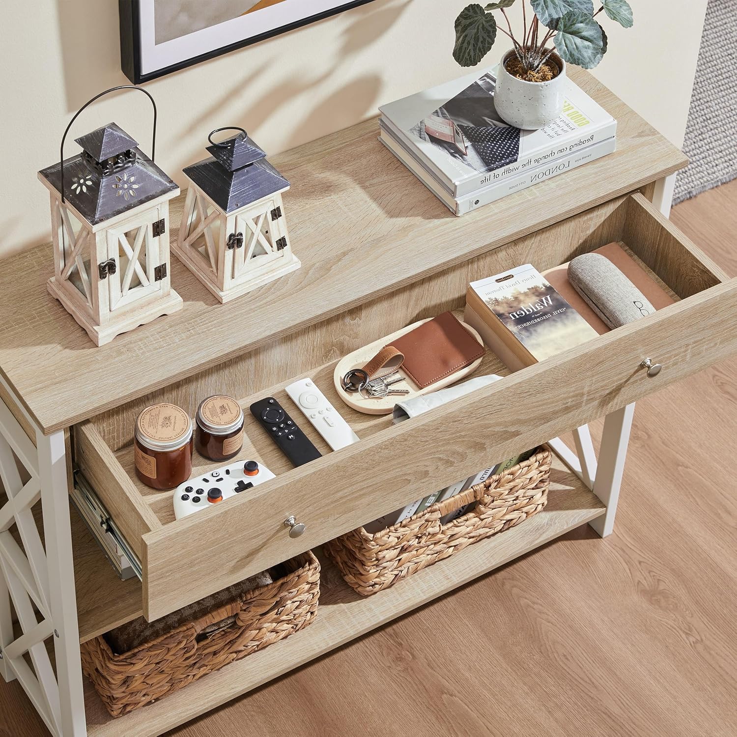 Image showing the open drawer of the TV stand filled with various items.