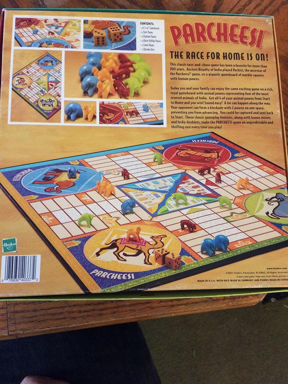 Parcheesi game box opened showing game board, pawns, and dice