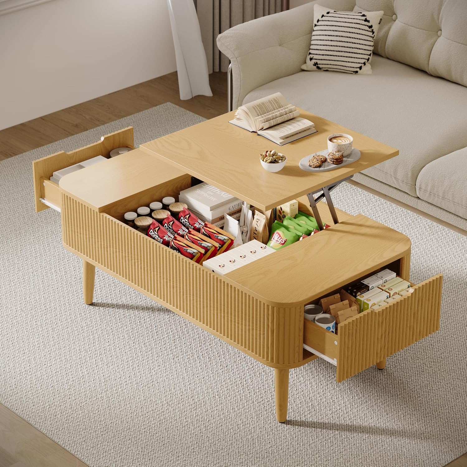 TOKSOM coffee table with lift-top raised, revealing hidden storage compartment filled with snacks and books, and open drawers.