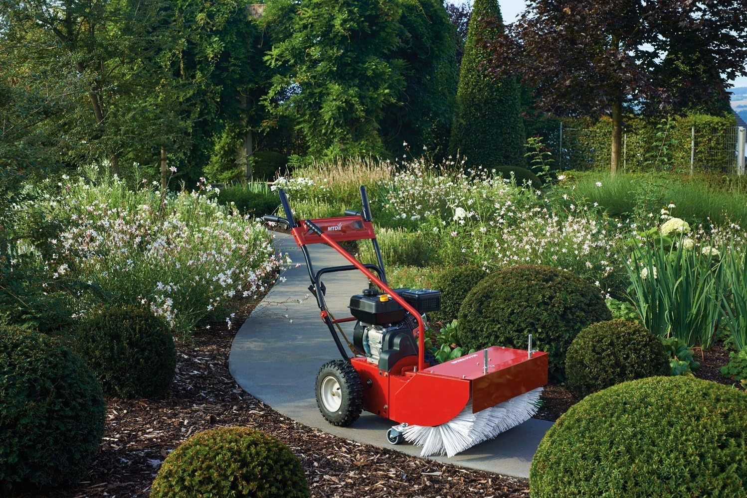 MTD Optima PS 700 Sweeper in operation on a garden path