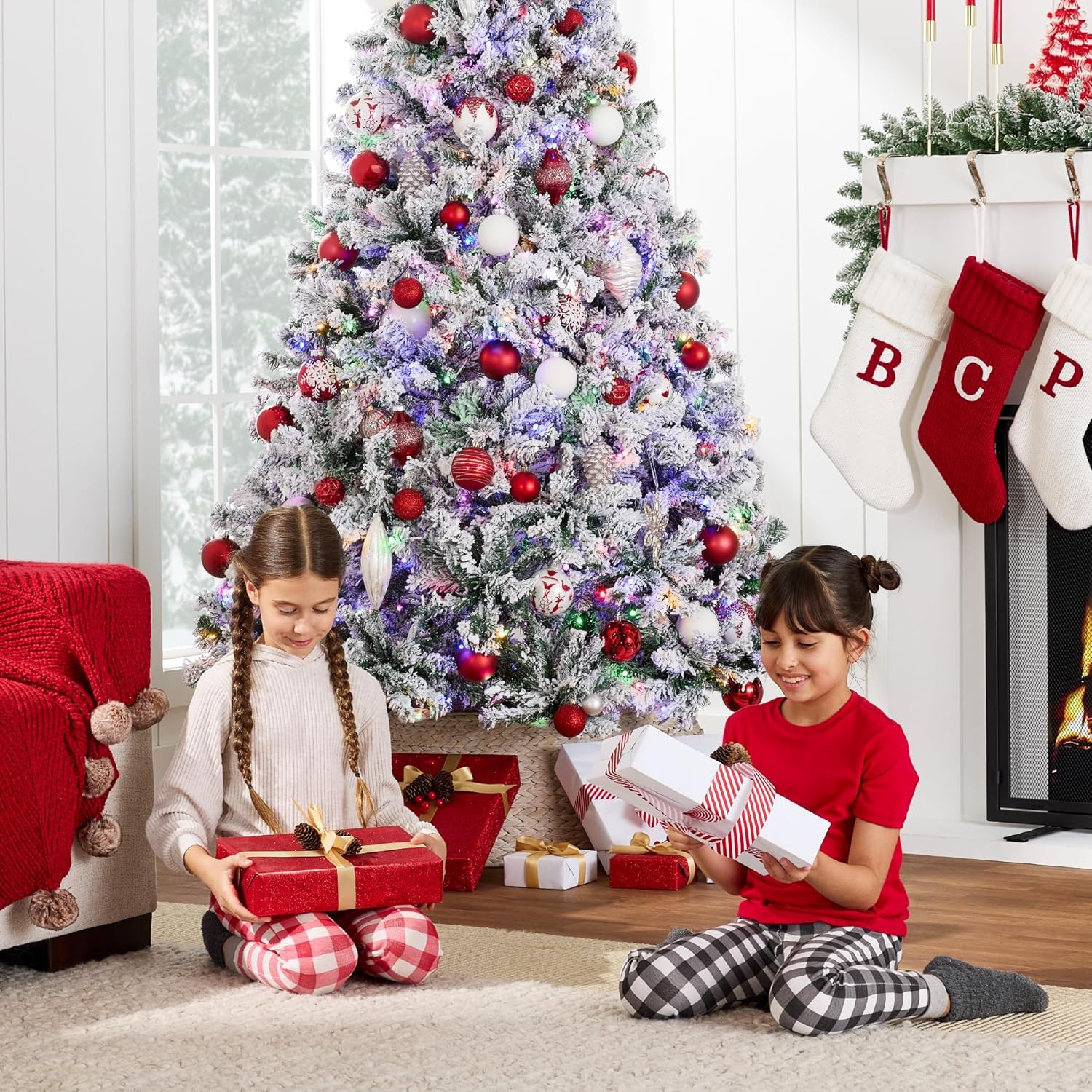 Close-up view of the snow-flocked branches of the artificial Christmas tree, highlighting the texture and white finish.