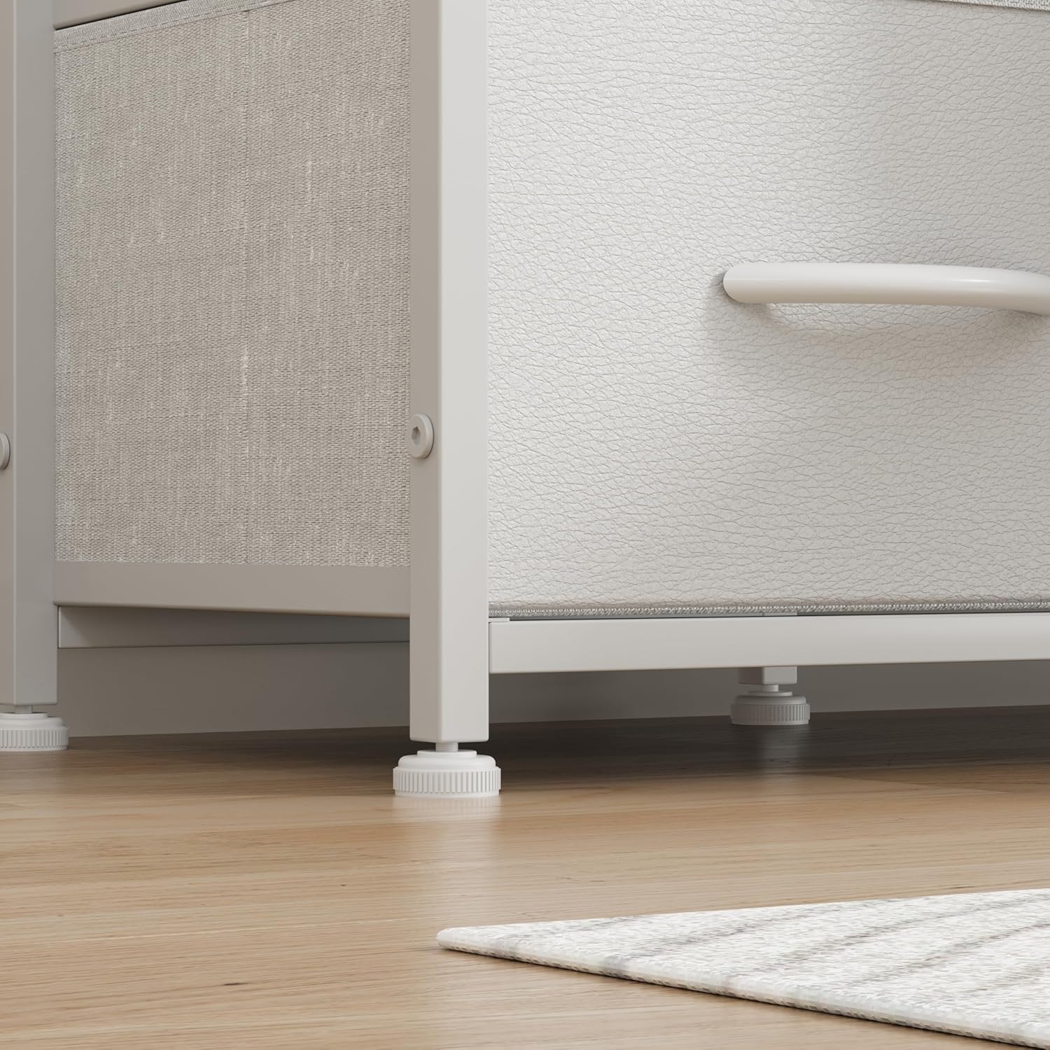 ക്ലോസ് അപ്പ് view of the adjustable feet at the base of the dresser, showing how they can be used to level the unit.