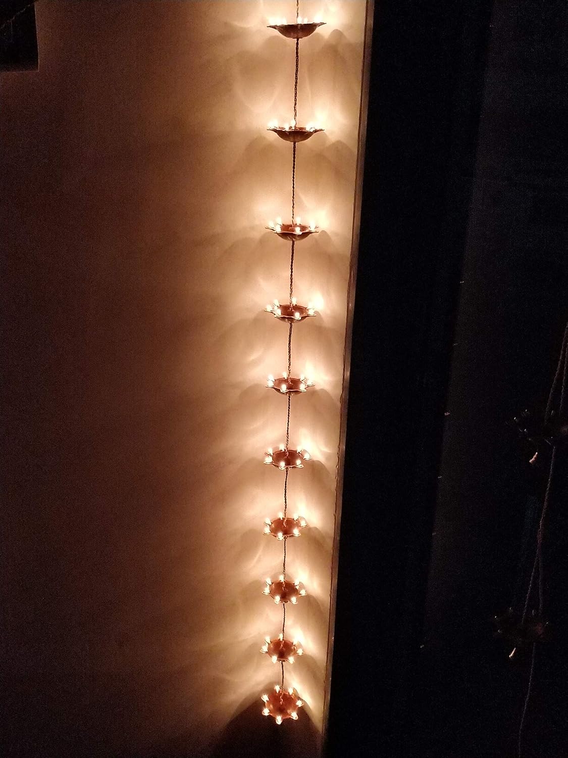 A Pair of Hanging Illuminating 10 Diyas with Bell at The end