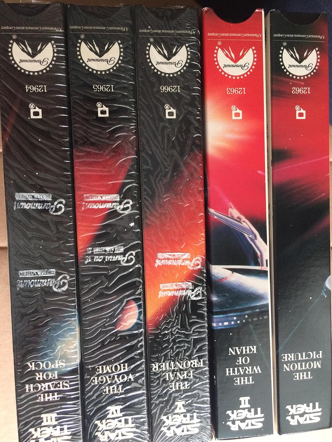 Star Trek. The Movies. 25th Anniversary Collection. 1991. 5 Videotapes in Cloth box with 5 VHS tapes in VHS boxes with pins. Includes Star Trek, The Motion Picture, The Wrath of Khan, The Search for Spock, The Voyage Home and The Final Frontier.