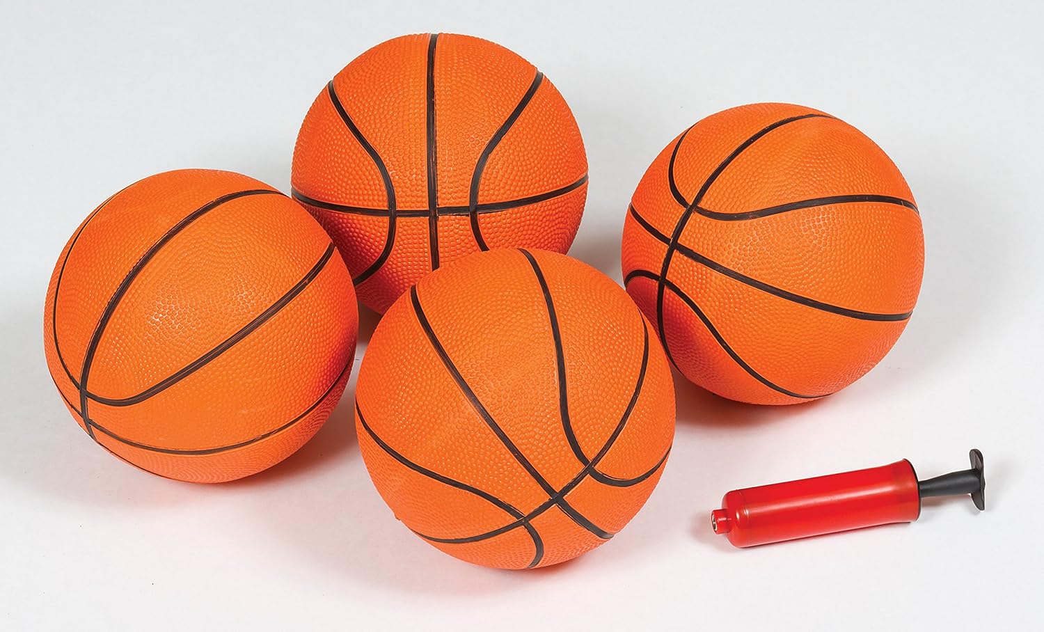 Four orange basketballs and a red hand pump