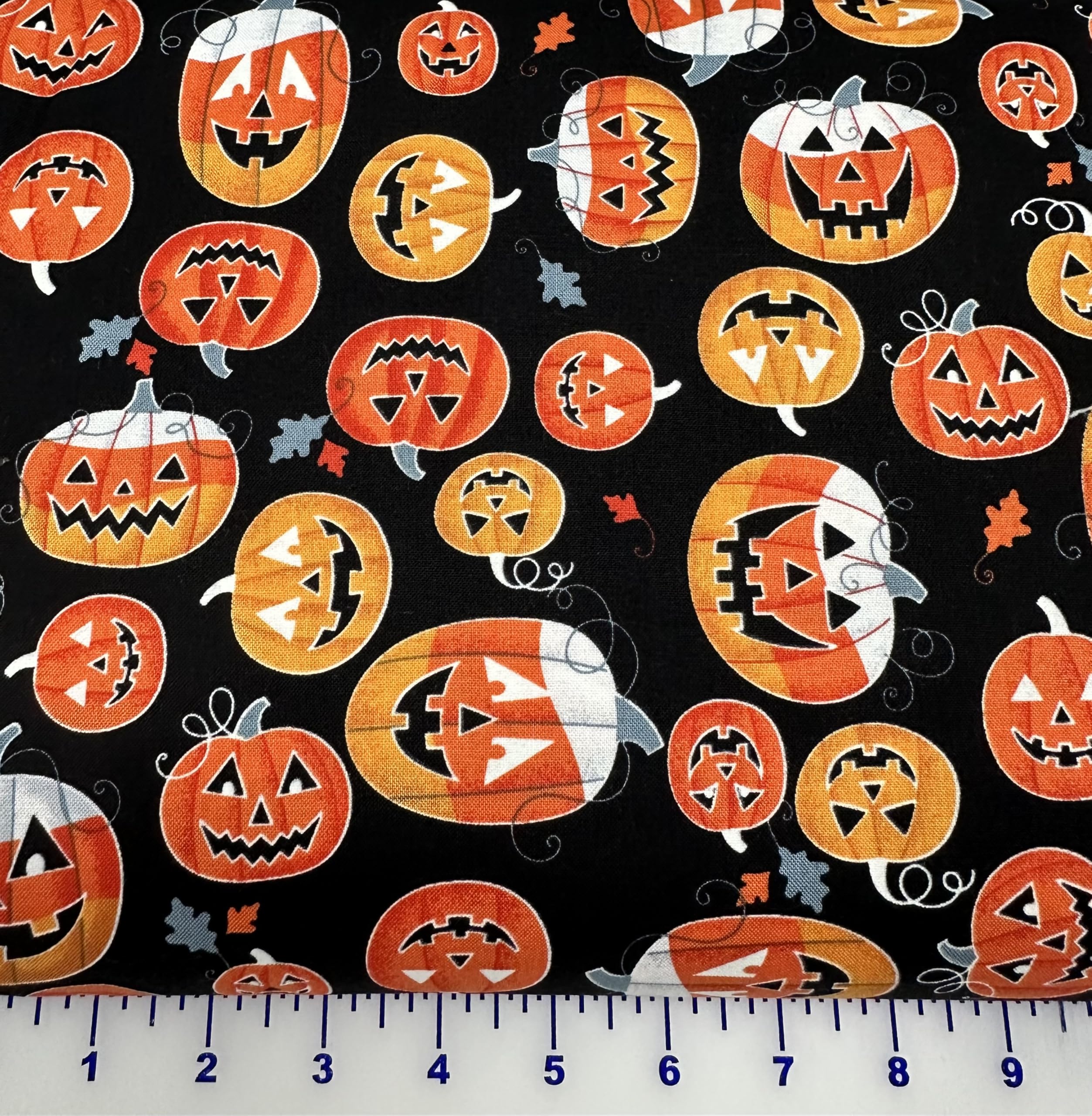 Benartex Cotton Fabric Glow-O-Ween Halloween 12960G-12 Glowing Candy Corn Funny Pumpkins on Black Background by The Yard