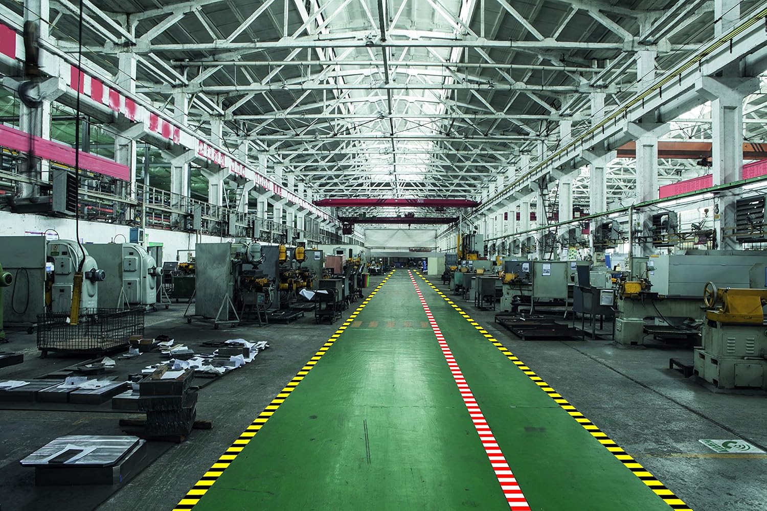 Factory floor with yellow and black safety marking tape applied