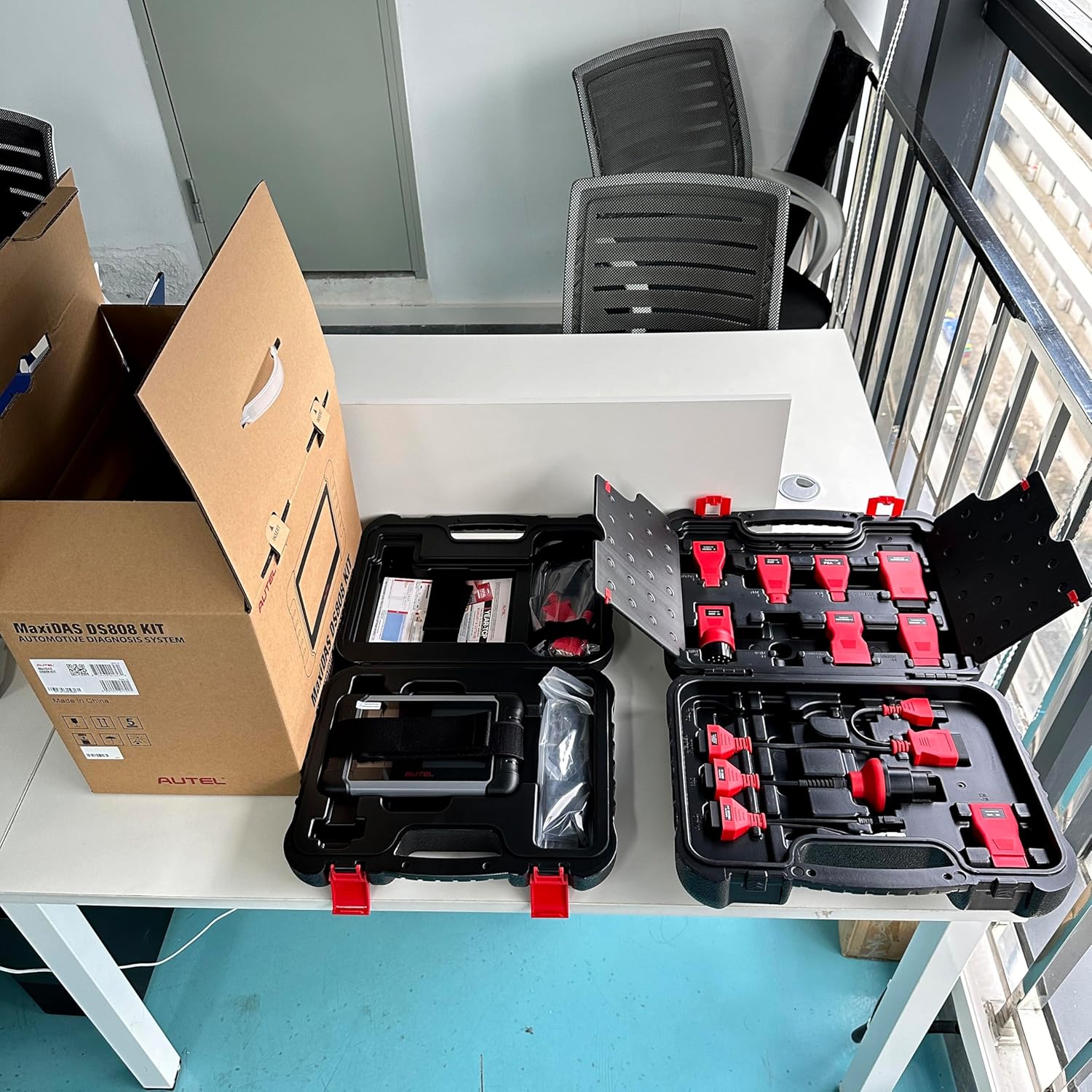 Open case displaying a variety of OBD adapters for the Autel MaxiDAS DS808 KIT.