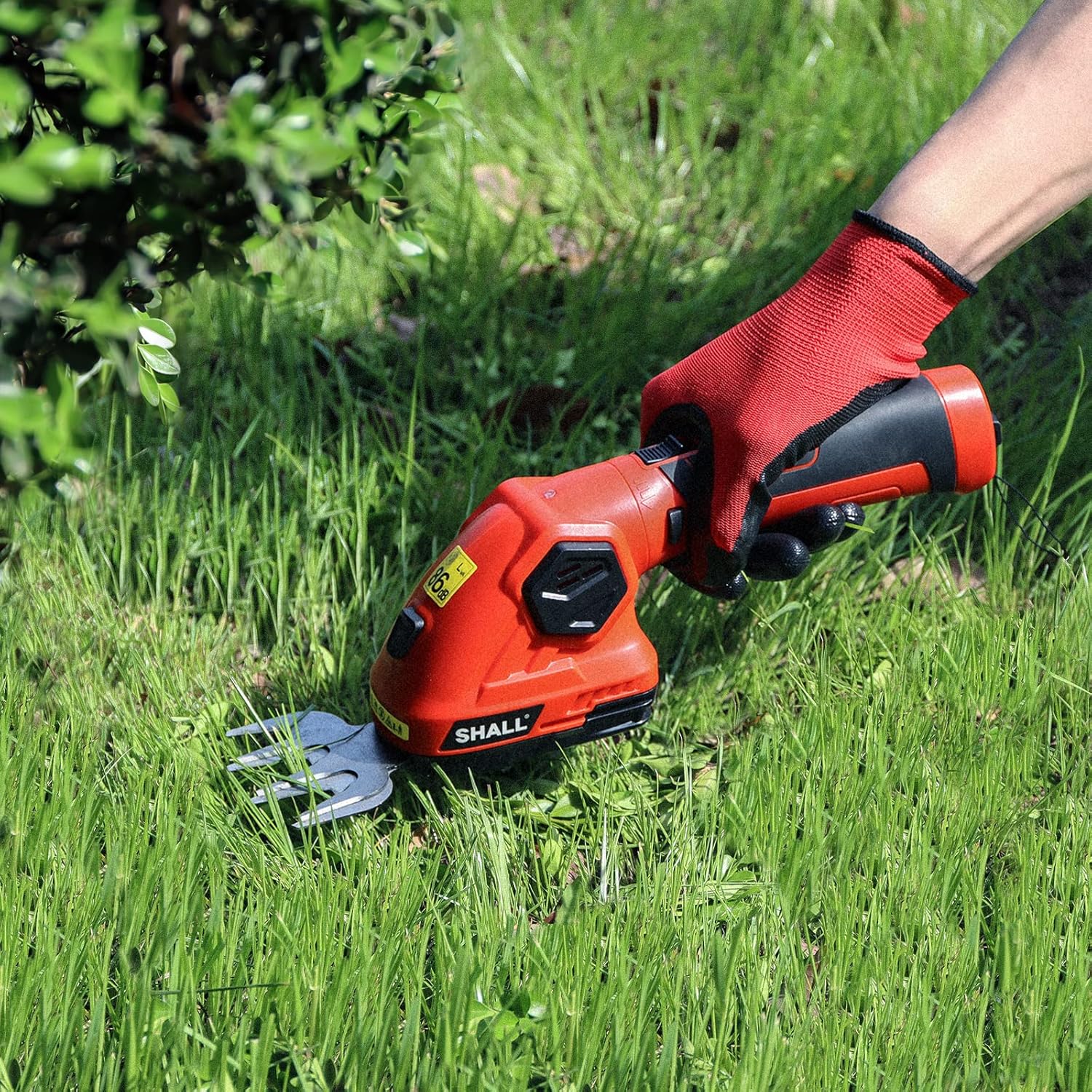 Person using the SHALL trimmer with grass shear blade to trim lawn edges