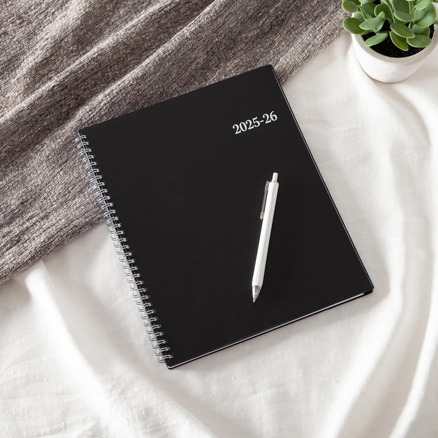 Blue Sky 2025-2026 Academic Year Planner Calendar on a desk with a pen