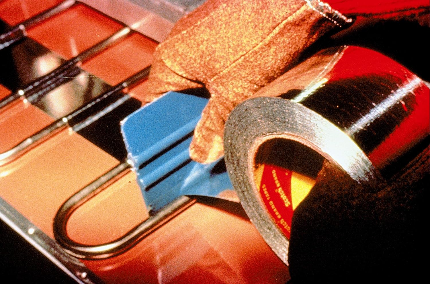 Hand applying 3M Aluminum Foil Tape with a squeegee