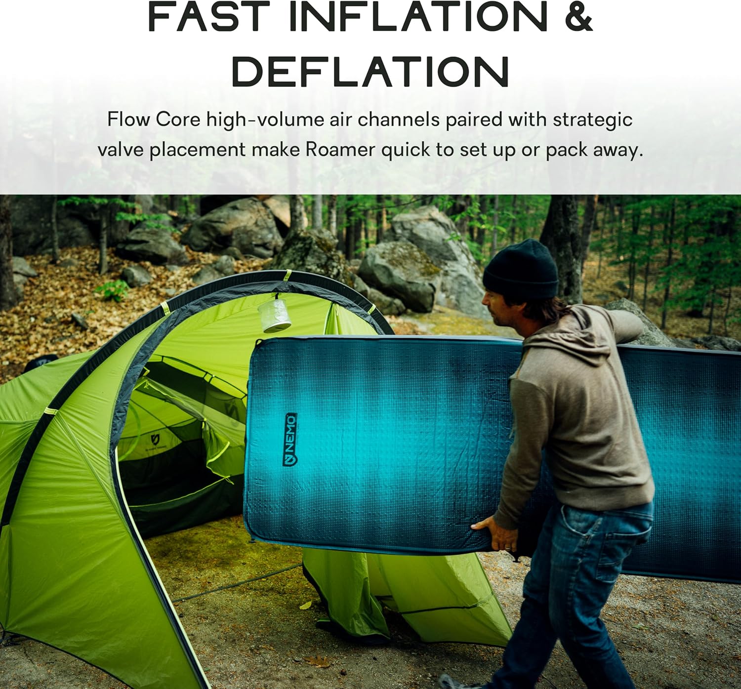 Person unrolling and setting up the NEMO Roamer Double Sleeping Pad outside a tent.