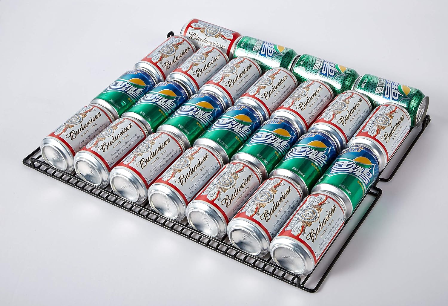 Close-up of beverage cans on a removable wire rack inside the refrigerator.