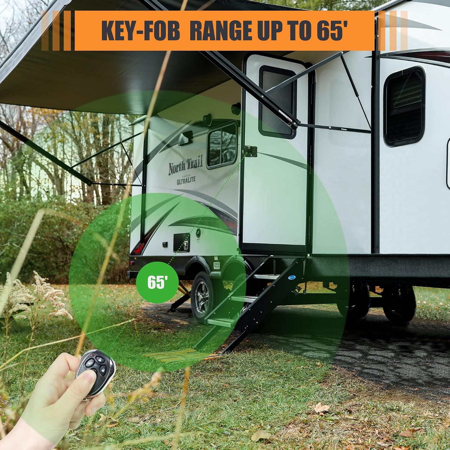 Image showing a hand holding the remote key fob, demonstrating its range of up to 65 feet from an RV.