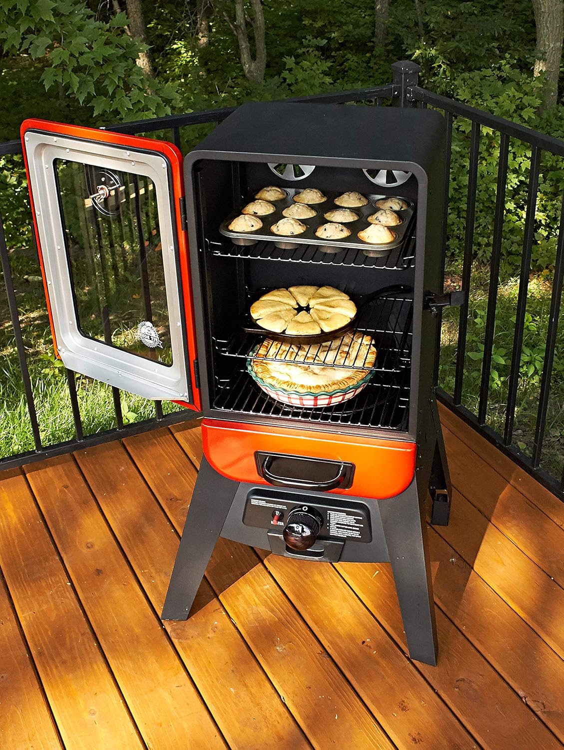 PIT BOSS Vertical LP Gas Smoker with door open, showing food on racks