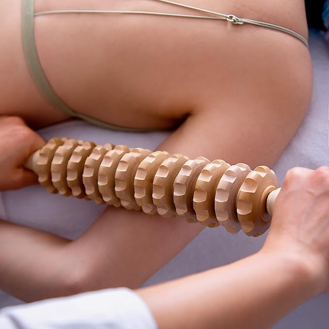 The Wooden Roller Manual Massager with 12 rotatable rollers is a high-quality product designed to provide instant results. Made from 100% natural wood, this massage tool is smooth and durable, making it perfect for relaxing muscles in the shoulders, waist, arms, legs, and more. The non-slip handle allows for easy gripping, while the smooth massage roller helps to expel toxins and fat, tighten skin, and eliminate excess fat in the lymphatic system. Professionals recommend this Wood Therapy stick for its effectiveness and ability to provide relief to large muscle groups like upper arms, back, hamstrings, and thighs.